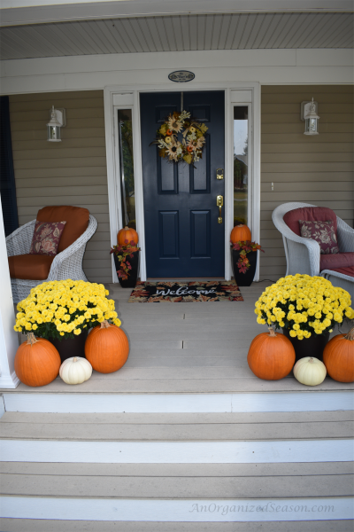Porch Decorated for fall pumpkins, wreath, flowers