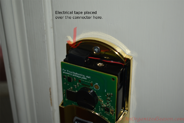 inside Schlage keyless door lock, tape connection on top to make it more secure from door vibration