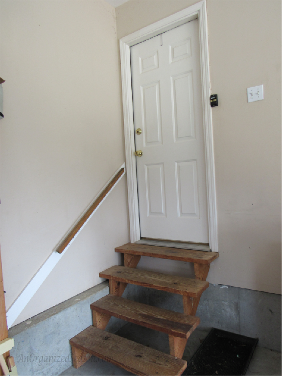 plain old entryway in garage. not much functionality, bare steps