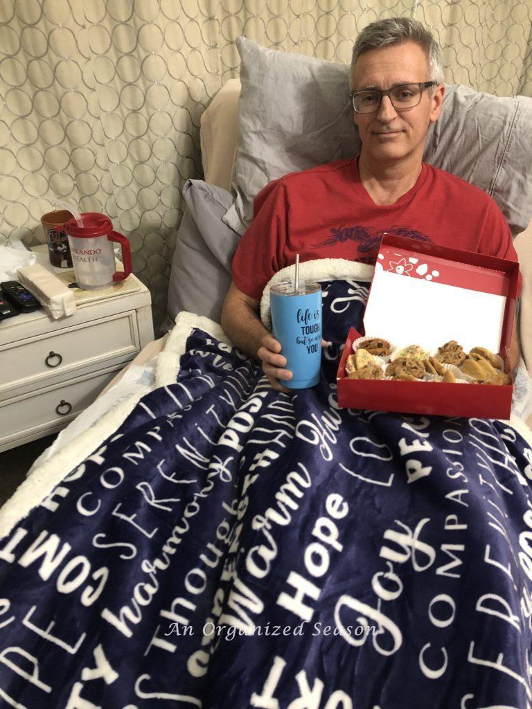 Rich holding gifts his co-workers sent him while recovering from surgery for prostate cancer.