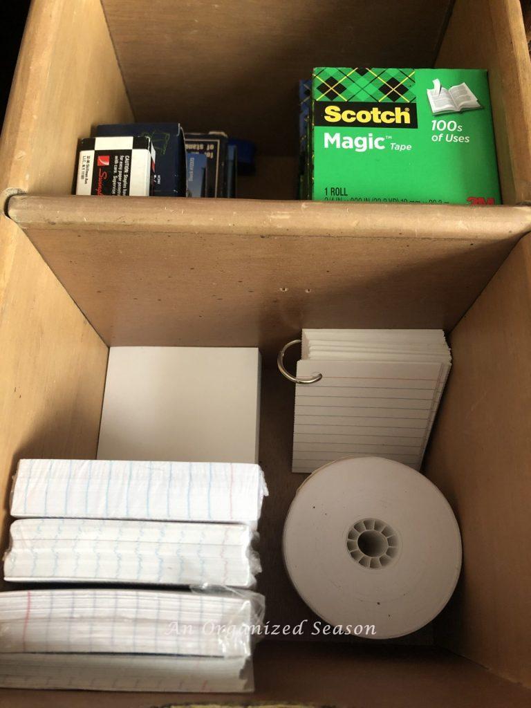 A drawer with removeable sections to store extra office supplies.