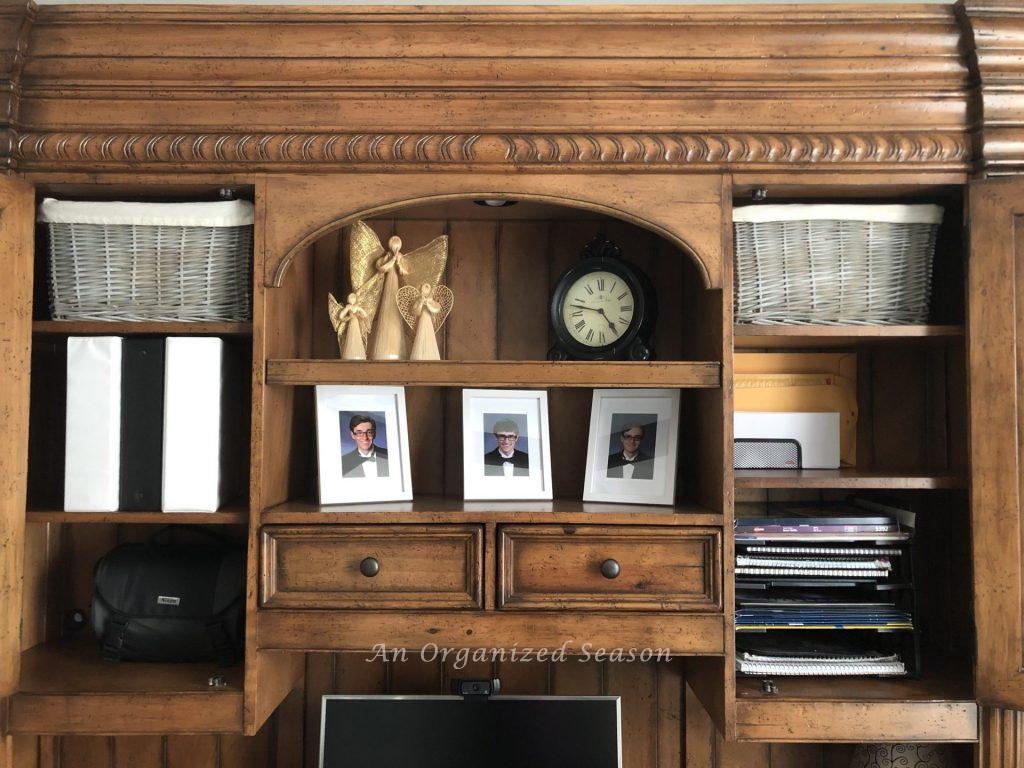 Cabinets in the desk using different types of storage to hold office supplies.
