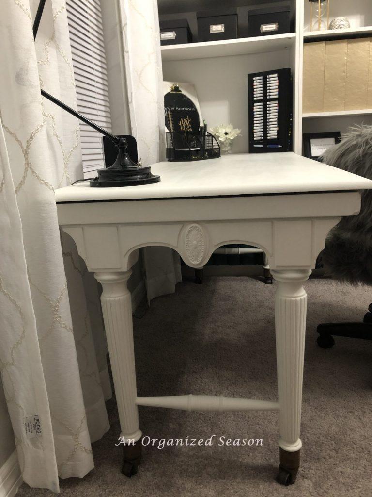 A desk that my husband built from my Grandmothers piano and that I painted white to match the room.