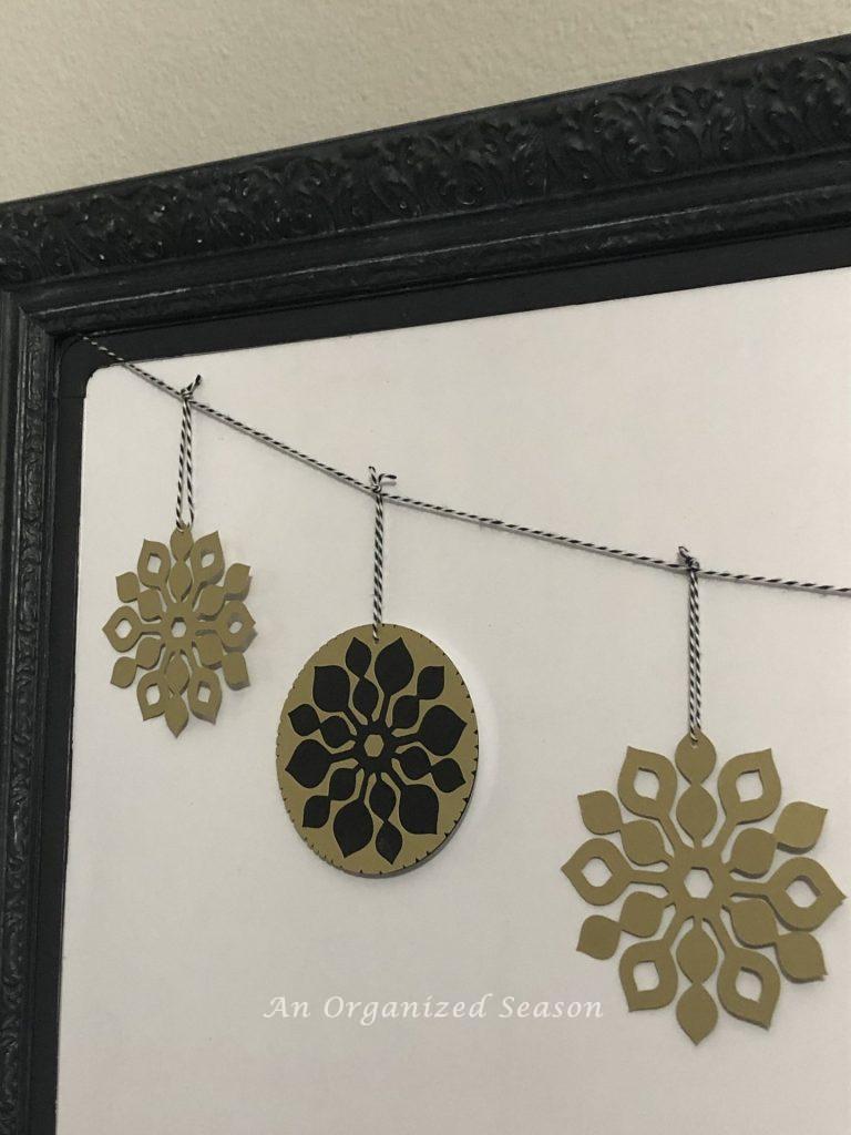 A banner I made of black and gold snowflakes hanging from a black and white string.