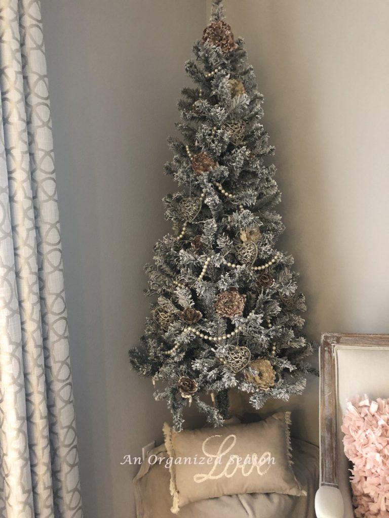Christmas tree with a pillow below that says "love"