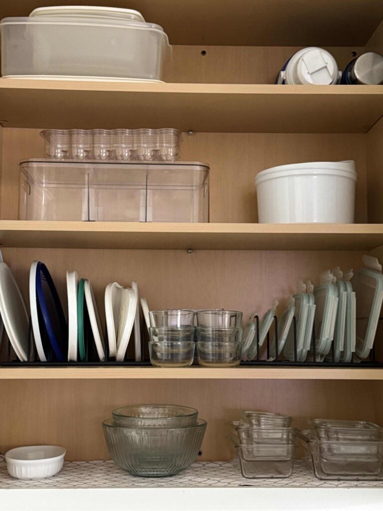 food storage containers organized in a kitchen cabinet