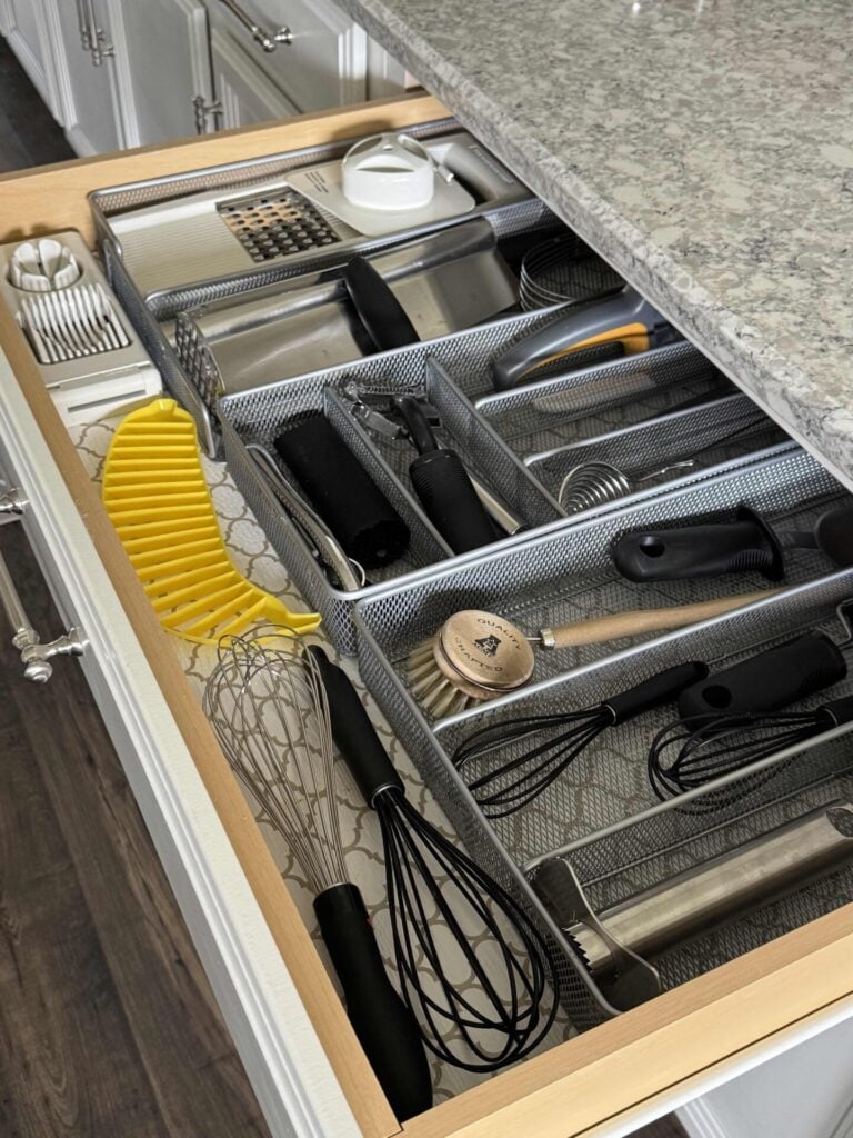 An organized kitchen drawer filled with items to prep food. 