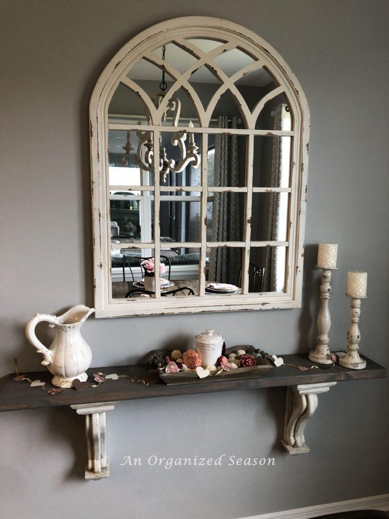 White mirror hanging above a shelf completing step six of my eat-in kitchen makeover
