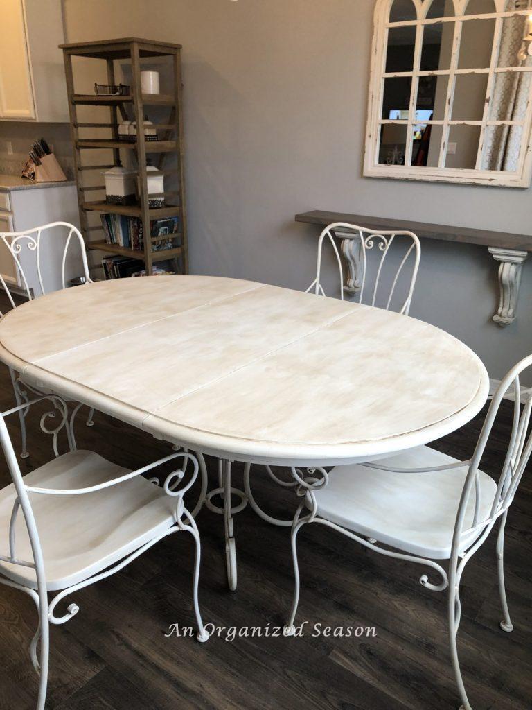 White kitchen table set after being painted with chalk paint. 