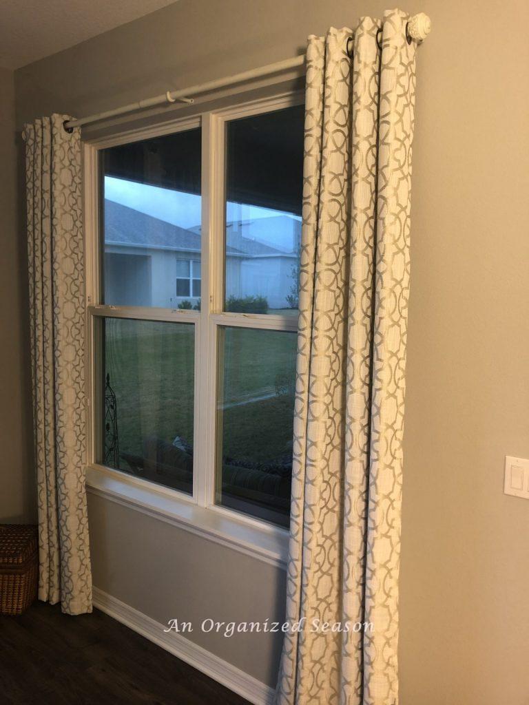 Curtains hanging on windows completing step one in achieving my eat-in kitchen makeover