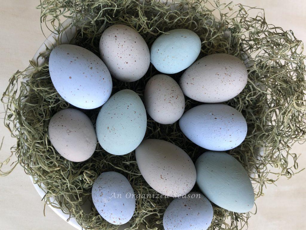 A nest of speckled eggs showing the finished product of my how to make speckled eggs for spring decor post.