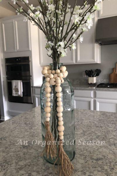 How to Make a Wood Bead Garland with Tassels at AnOrganizedSeason.com