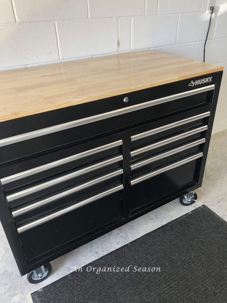 Black Husky mobile workbench and tool storage chest. Will be used to store and organize tools completing steps to garage organization.