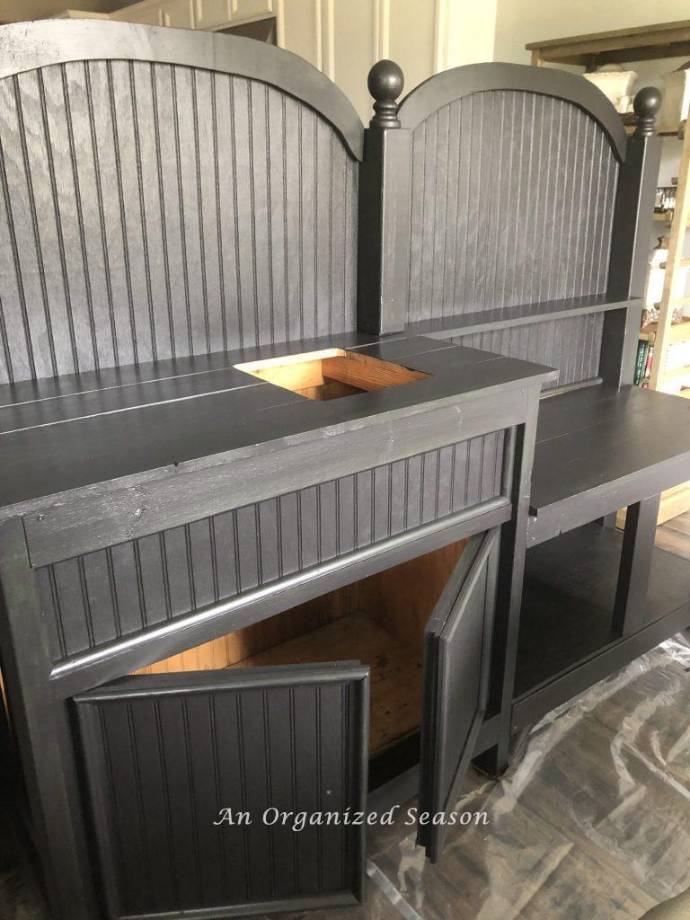 Potting bench with new black paint job.  Shows the finished product for how to give new life to an old potting bench. 