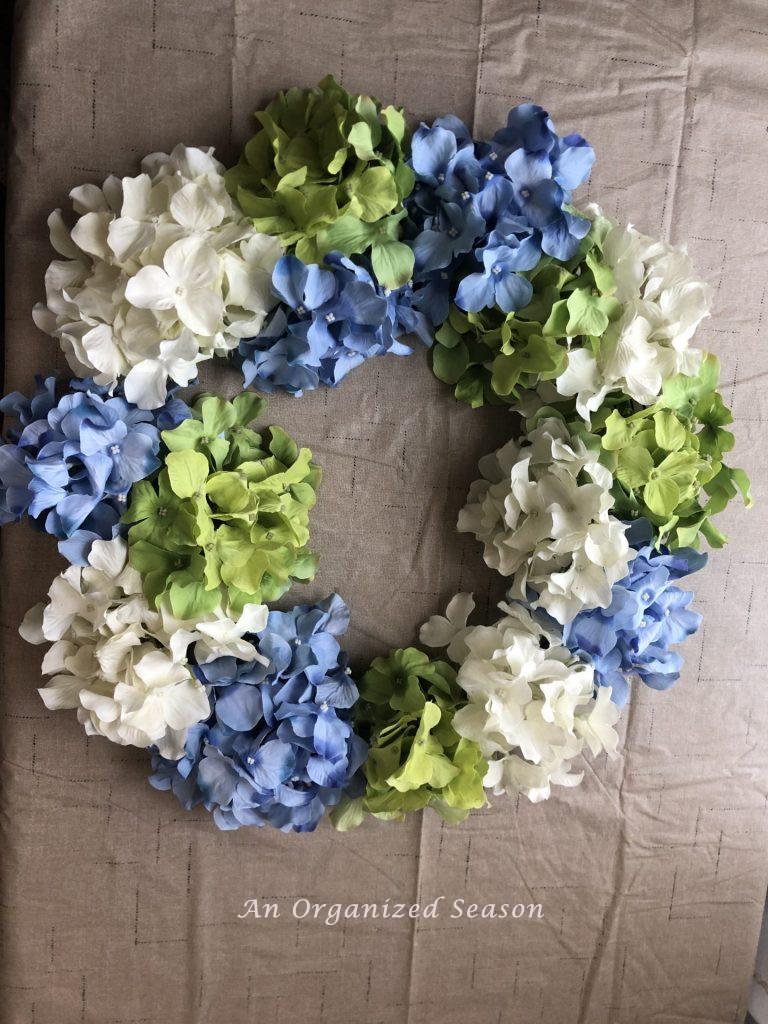 Completed hydrangea wreath showing how to make a spring wreath using hydrangea. 