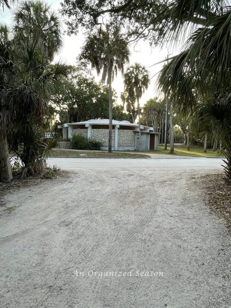 A round stone and concrete building that provides bathroom facilities while camping at beautiful Fort De Soto campground.