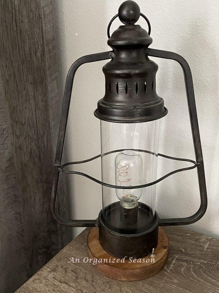 A rustic lamp sitting on a desk. An example of an accessory used to makeover a bedroom into a rustic retreat.