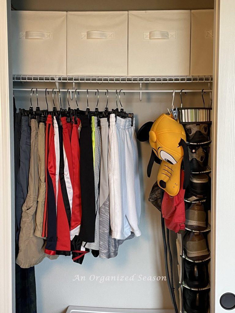 To organize a kid's bedroom closet, hang all of the shorts together. 