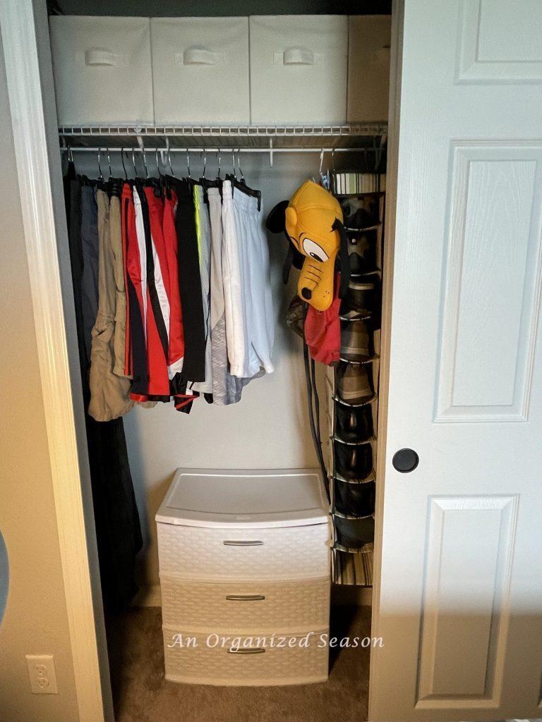Shorts hanging in an organized closet.