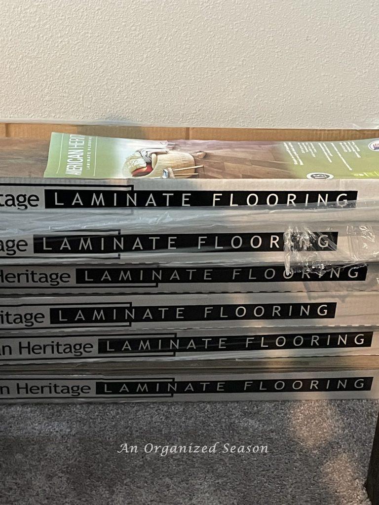 Six boxes of wood laminate flooring. Step one of advice for installing flooring on your walls.