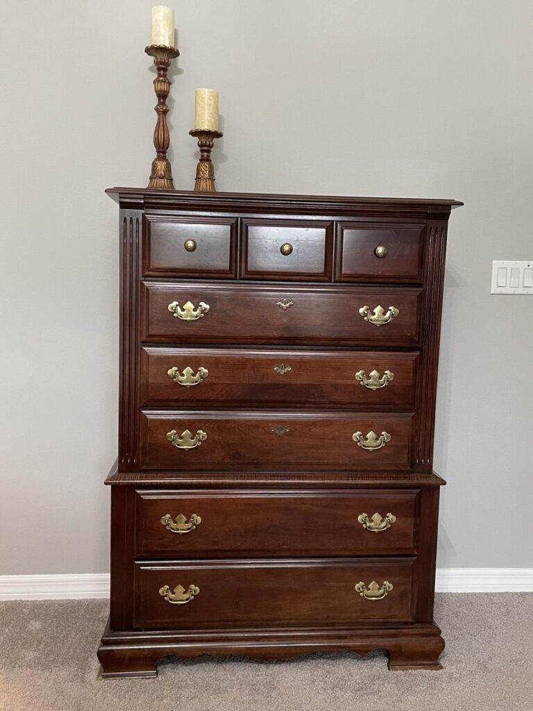 A brown chest of drawers.