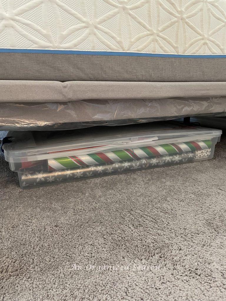 Store wrapping paper in a plastic container under your bed as a simple solution to organize your master bedroom.