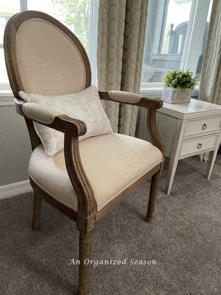 A cream Louis style upholstered chair. 