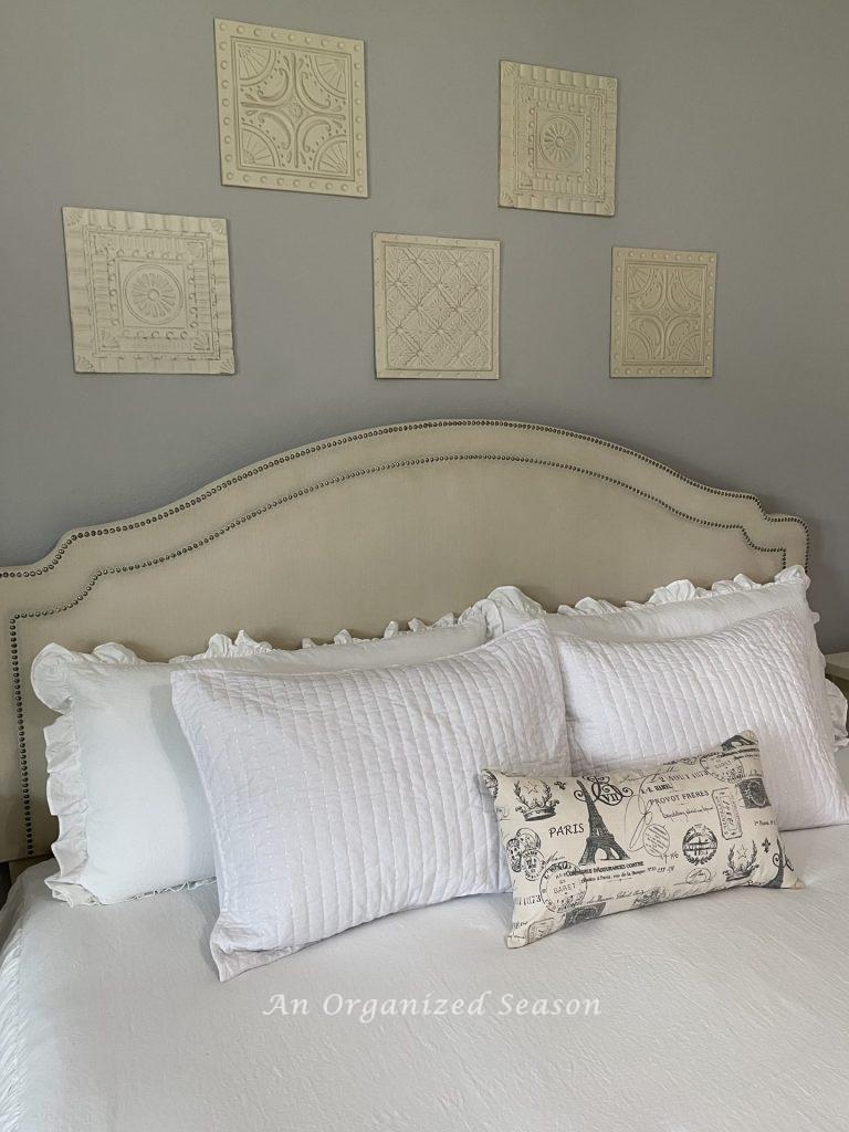 Step six to achieve a master bedroom makeover is to address the wall art.