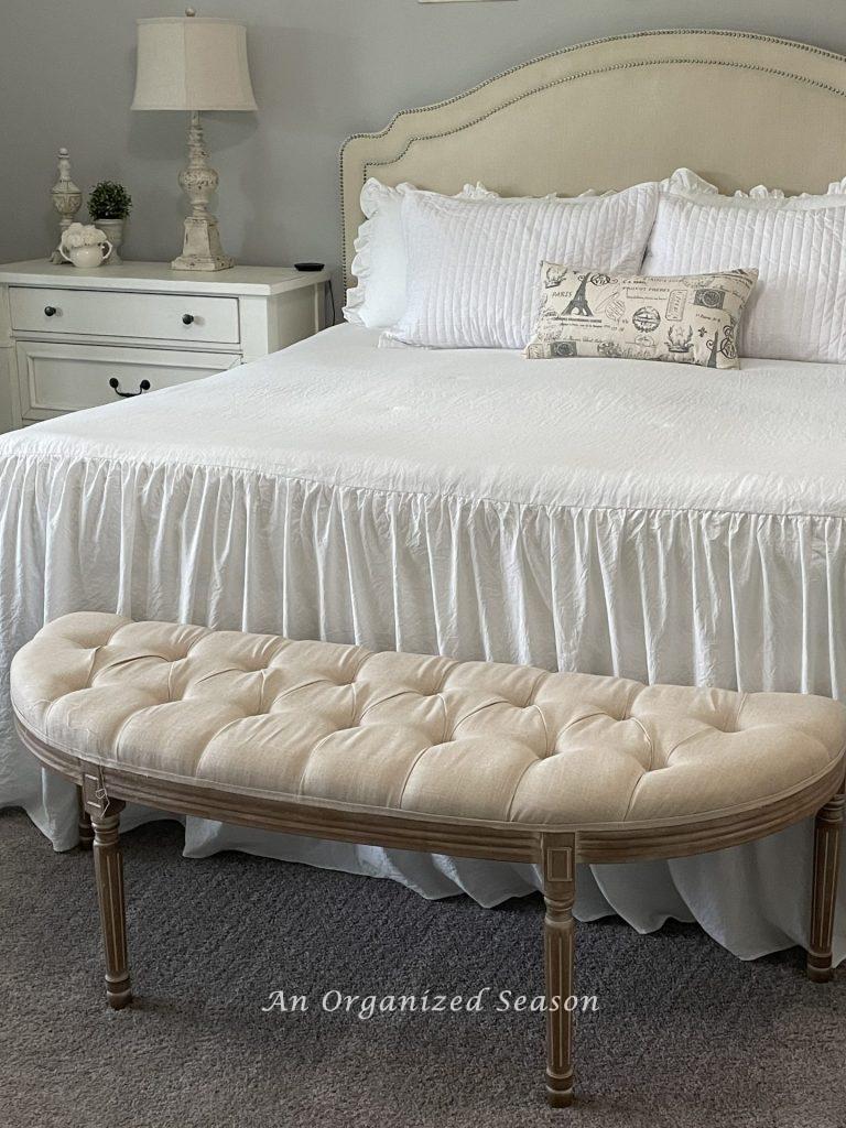 Use a bench at the end of your bed to store decorative pillows while sleeping to keep your master bedroom organized.