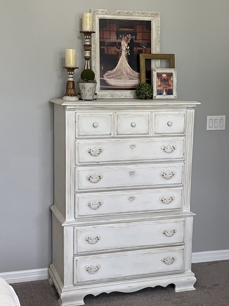 A chest of drawers painted white. 