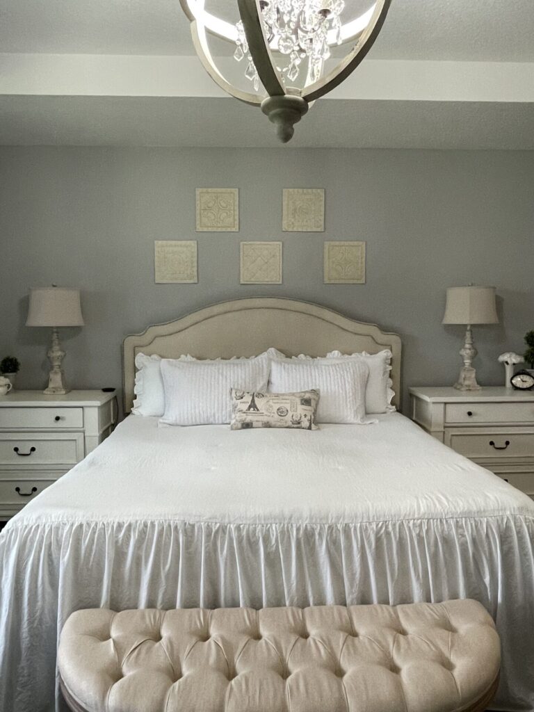 A bed with a headboard that was painted cream.