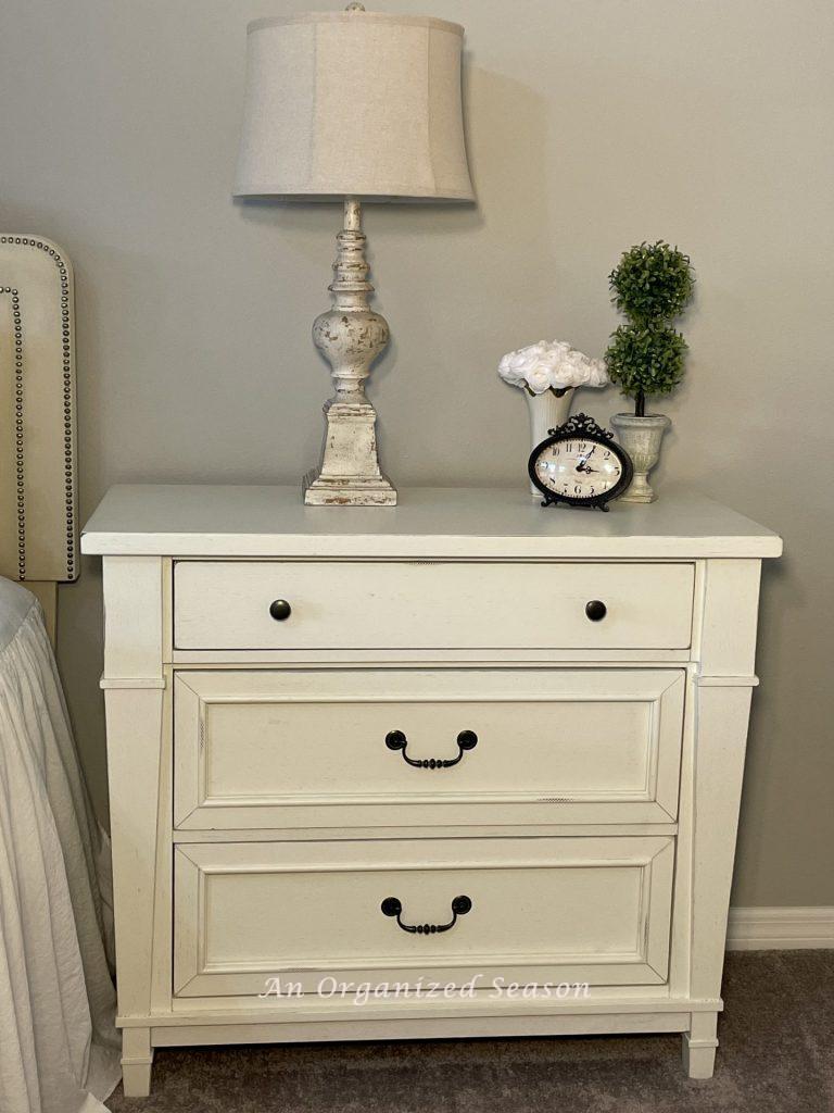 Use a nightstand with drawers to store items in your master bedroom.
