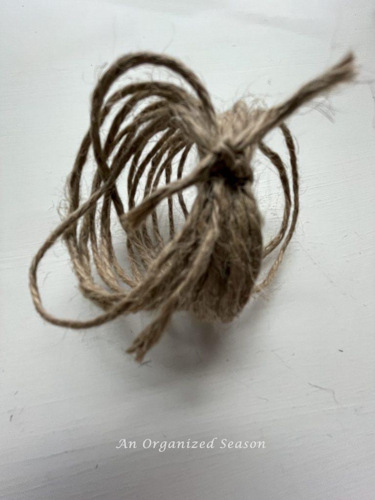 Jute twine that's been wrapped 20 times and then securely knotted to make two types of twine pumpkins.