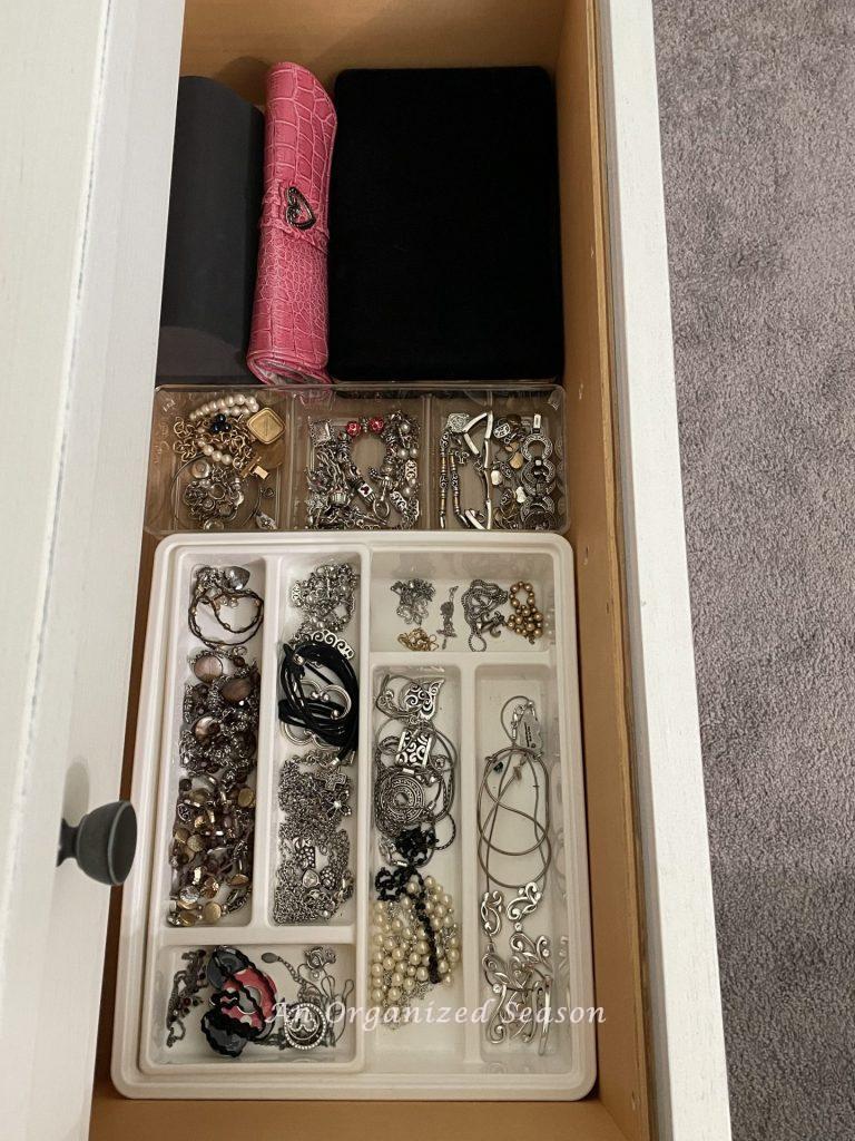 Use plastic storage bins inside your dresser drawers to organize your jewelry in your master bedroom.