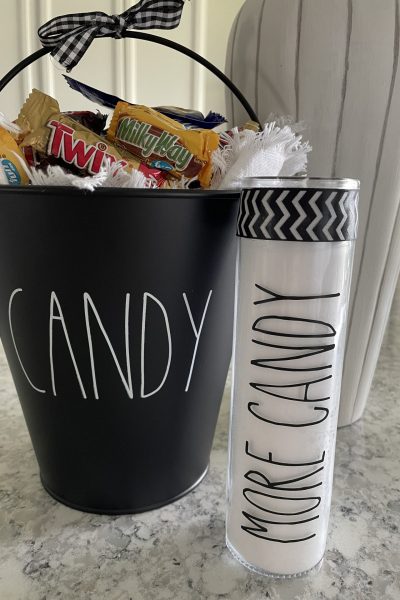 A Rae Dunn inspired candle that says "more Candy" that you can learn how to make!