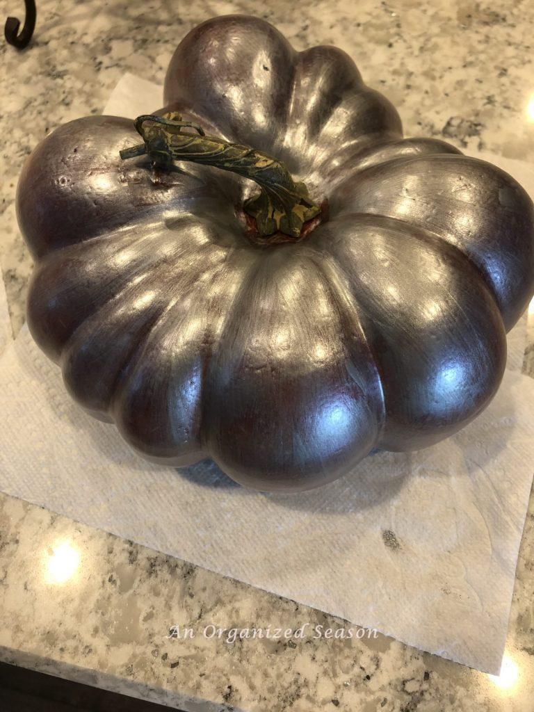 A faux pumpkin that has been painted with two coats of  paint, showing how to apply pearlescent paint on pumpkins. 