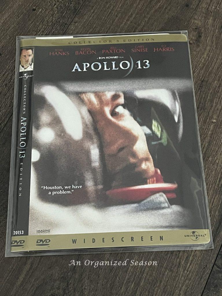 A plastic DVD sleeve with the jacket from Apollo 13 showing how to organize DVDs. 