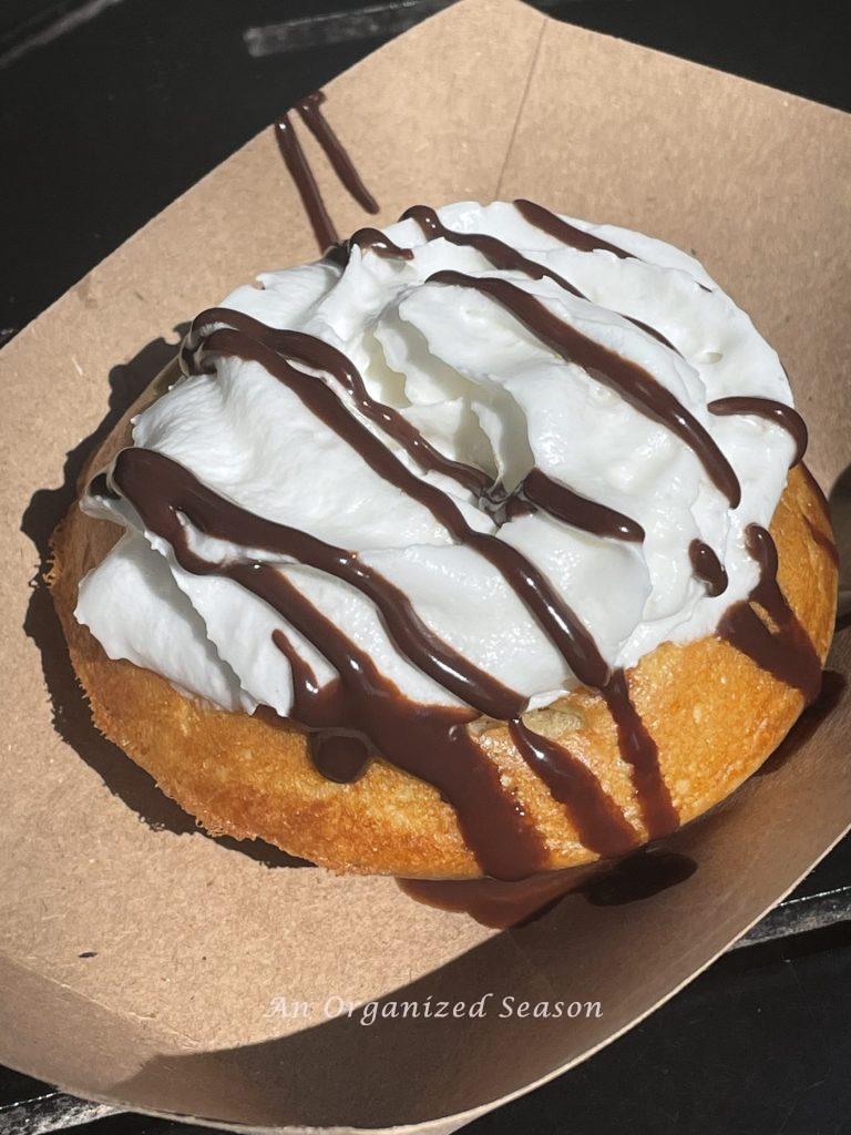 A small waffle with whipped cream and chocolate sauce from the EPCOT food and Wine Festival.