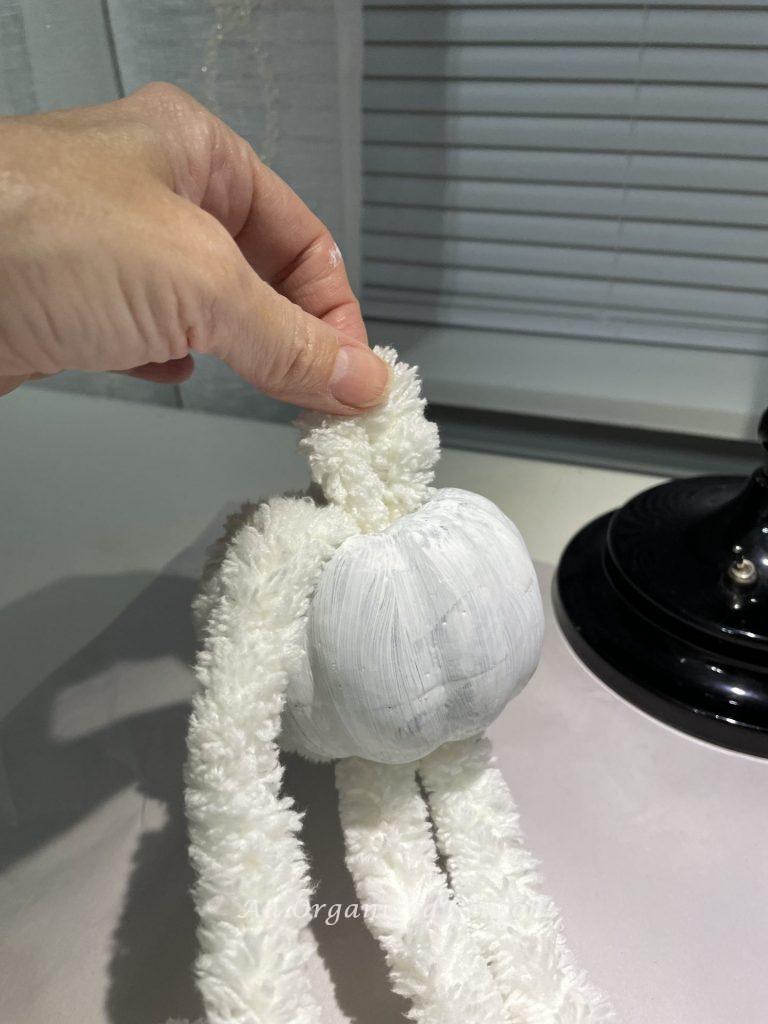 A faux pumpkin with yarn wrapped around it. Showing how to make an adorable yarn pumpkin. 