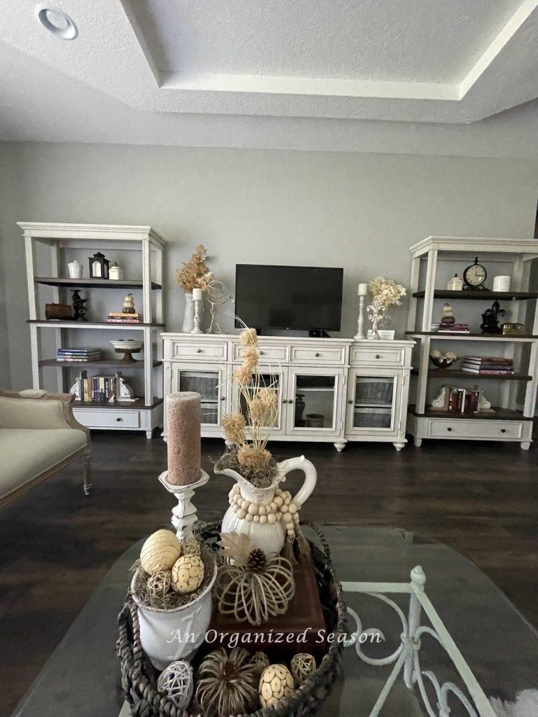 A living room decorated for Fall with neutral and natural elements. Showing the third room in the best of Autumn home tour. 