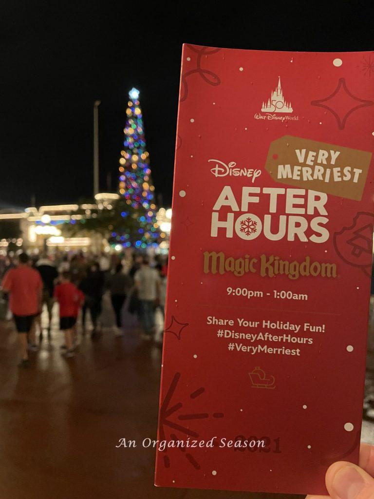 A person holding a map to use as a 
 complete guide to Disney's Very Merriest After Hours Party! 