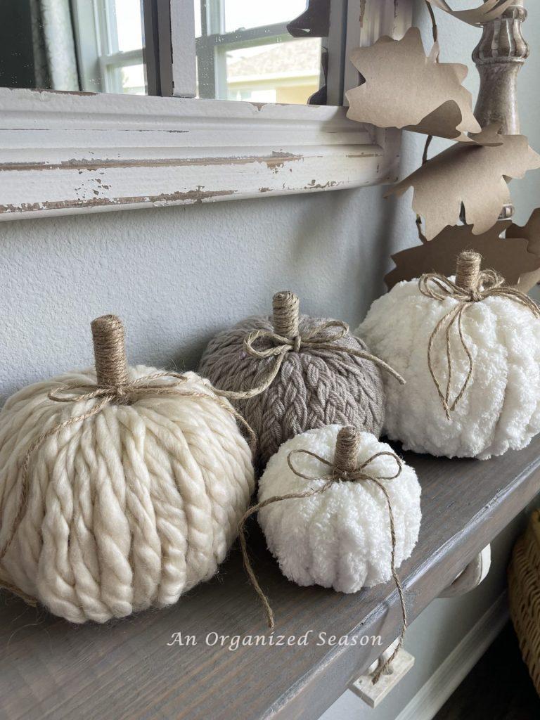 Four yarn pumpkins sitting on a shelf. My most popular post of 2021. 