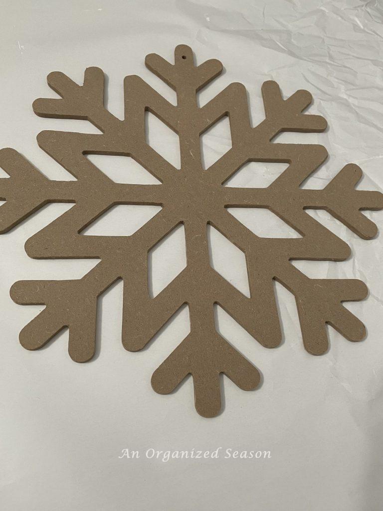 A cheap snowflake made out of pressed board that I will turn into a cute tree topper.