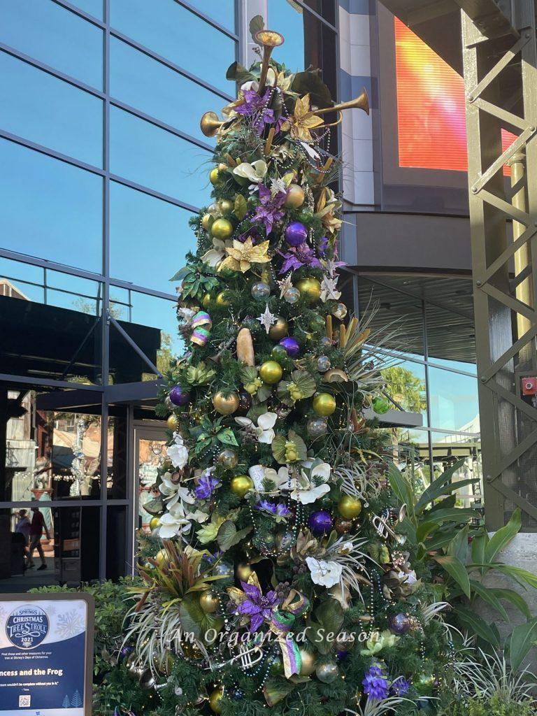 Beautiful purple and lime decor on the Princess and Frog themed tree on the Christmas tree stroll.