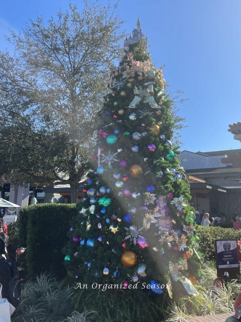 Large tree decorated with the icons of the four theme parks at Disney World at the 2021 Christmas tree stroll.