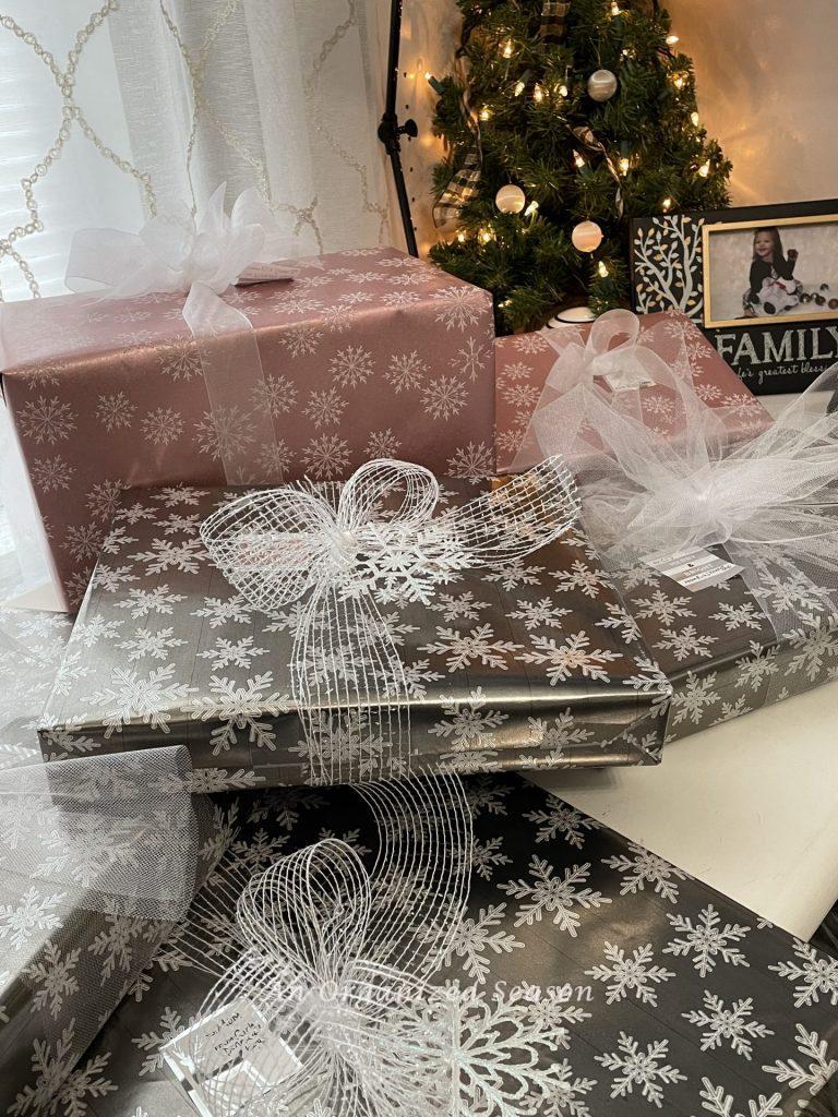 Christmas gifts wrapped in pink and silver paper. 
