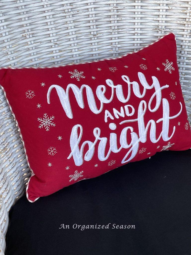 A red and white pillow adds to the holiday porch decor. 