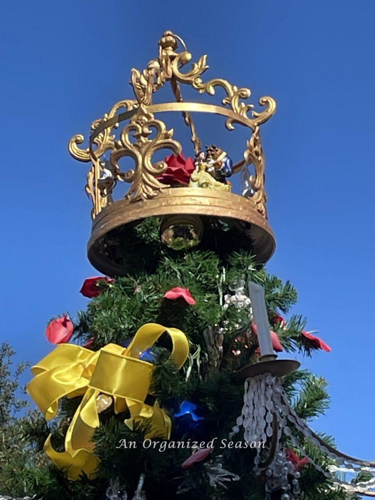 Beauty and the Beast dancing atop the Christmas tree on the 2021 Tree stroll.