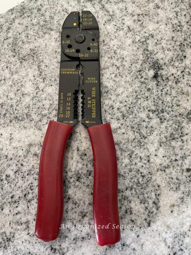 Wire strippers used to replace a bathroom light fixture.