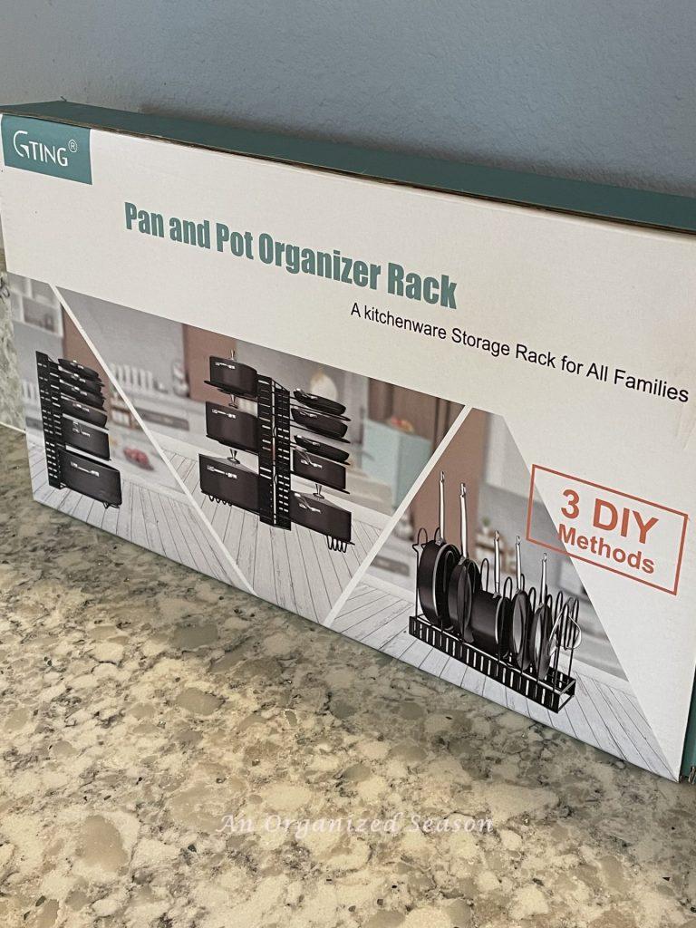 Purchasing a pan and pot rack is a  helpful kitchen cabinet organization solution!